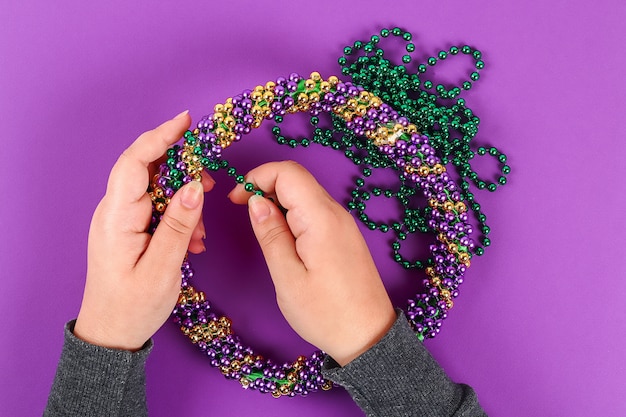 DIY wreath Mardi Gras, Fat Tuesday purple background.