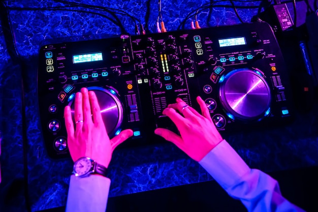 DJ driving music on professional equipment in nightclub