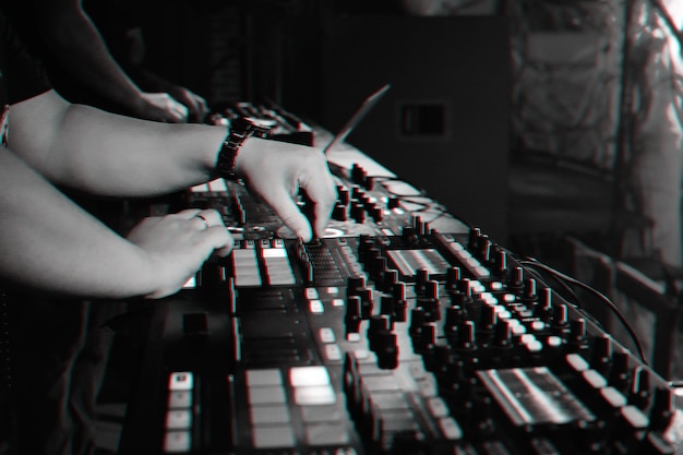 DJ mixes music on a professional controller Board in a nightclub at a party