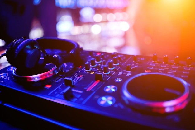 DJ remote controller in nightclub in perspective with professional headphones. High quality photo