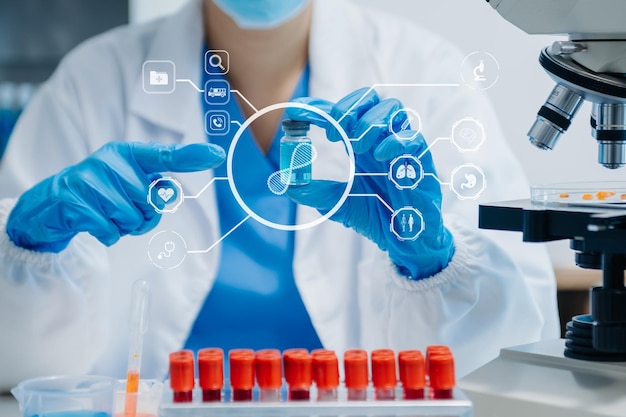 Photo dna molecule testing concepts the doctor in a mask examines dna molecules on the chemical laboratory with virtual icon