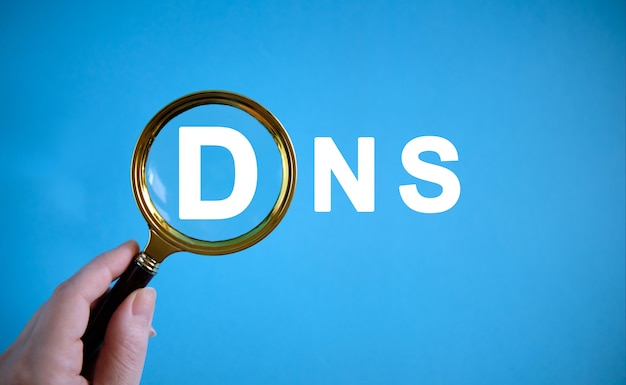 Photo dns - text with a magnifying glass on a blue background