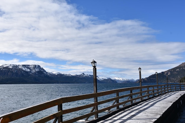 a dock with a view of a mountain range in the background