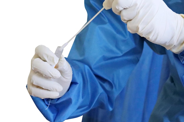 Doctor in blue suit and white gloves holding a dose of vaccine against a white background