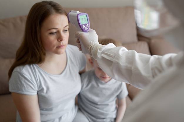 Doctor check patient body temperature using infrared forehead