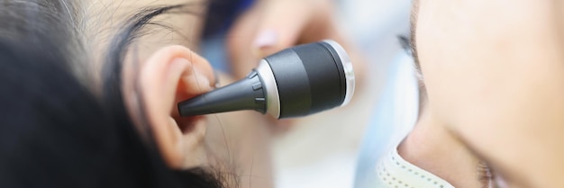 Doctor check patient on medical examination with special ear equipment