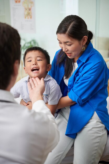 Doctor Checking Boys Throat