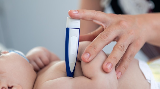 Doctor checking the temperature fever to small newborn with thermometer