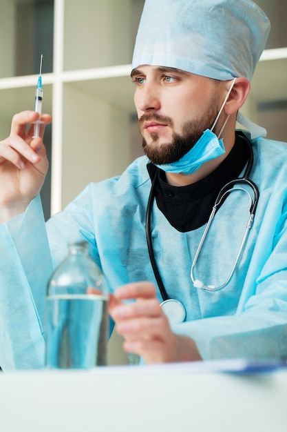 The doctor comes into a solution for injection in a syringe