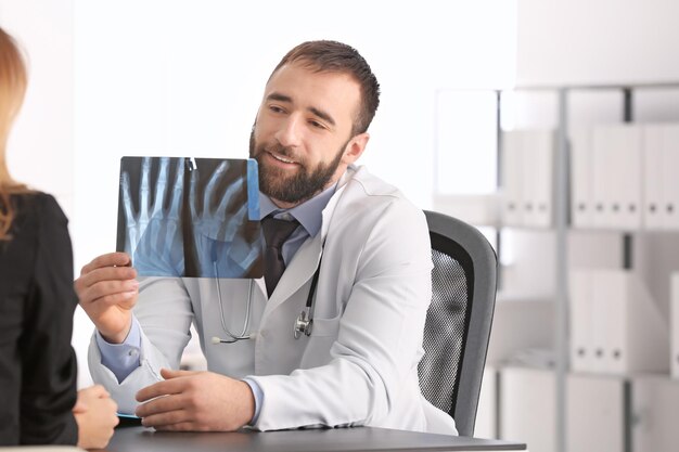 Doctor consulting female patient in clinic