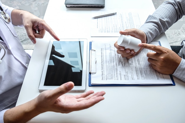 Doctor consulting with patient and checking sickness condition while presenting results diagnosis