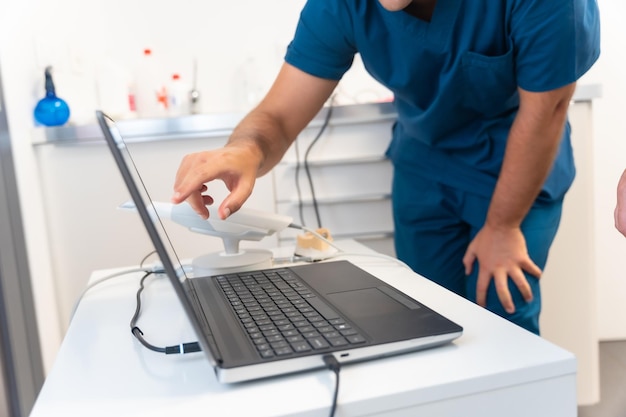 A doctor in the dental clinic explaining and looking at the 3d of the xray on the computer