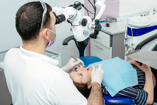 Doctor dentist uses a microscope