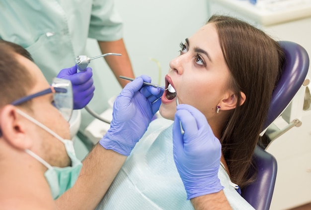 Doctor Dentist with an assistant work in a dental clinic.