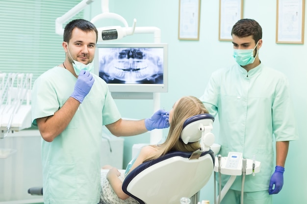 Doctor Dentist with an assistant work in a dental clinic.