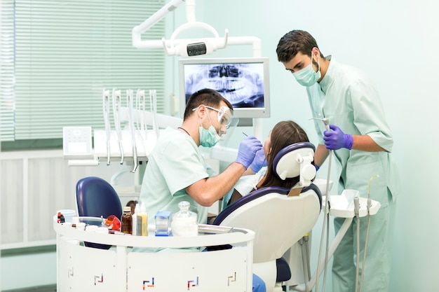 Doctor Dentist with an assistant work in a dental clinic.