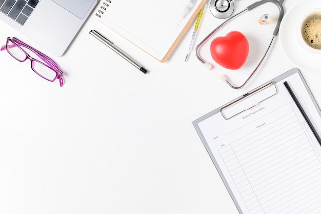 Doctor desk table with stethoscope and red heart