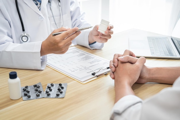 Doctor discussing with the patient using the medicine something and recommend treatment methods, Presenting results on report, Medicine and Healthcare concept.