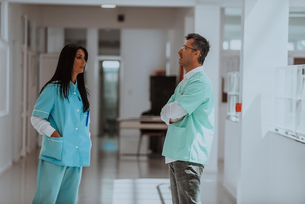 A doctor in a discussion with a nurse about medical problems and patient care in a modern hospital h