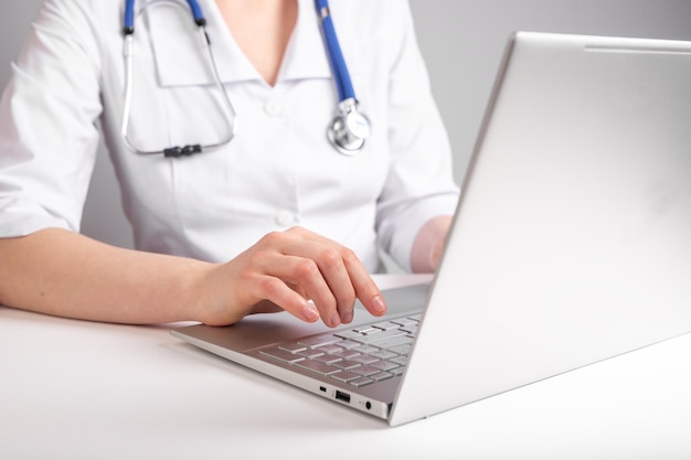 Doctor dr working at laptop using computer at workspace