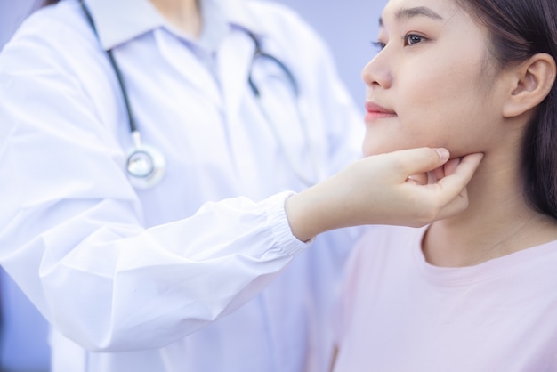 Doctor examination the back and neck of a women patient outdoor