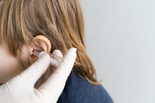 the doctor examines the child ear