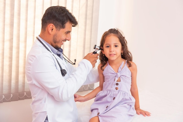 Doctor examines ear with otoscope in a pediatrician room. Medical equipment