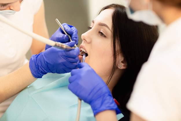  Doctor examines the teeth. Dental health prevention