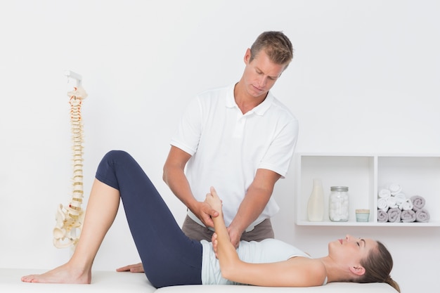 Doctor examining his patient arm