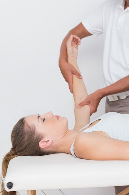 Doctor examining his patient arm