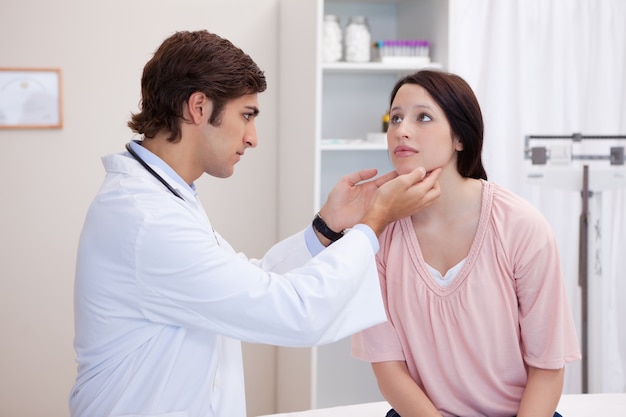 Doctor examining his patients jaw