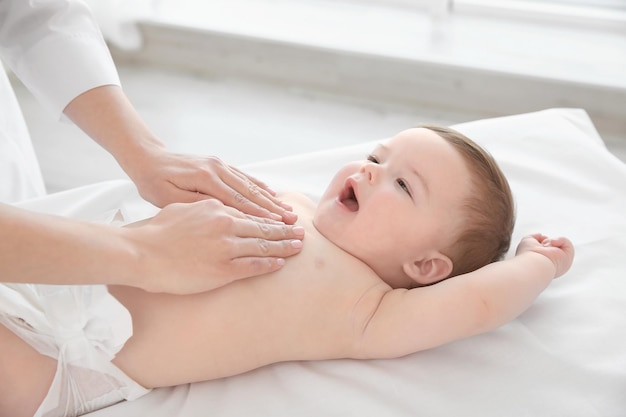 Doctor examining little baby in clinic Baby health concept