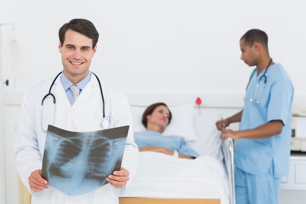 Doctor examining x-ray with patient in hospital