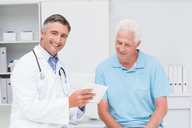 Doctor explaining prescription to senior man