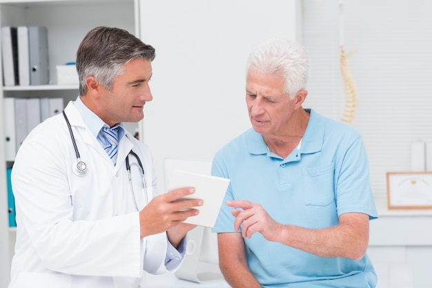 Doctor explaining prescription to senior patient