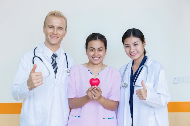 doctor and family consulting patient lying on hospital bed talking happy about the diagnos