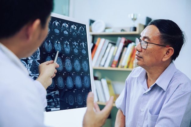 Doctor give advice to elderly patient about MRI (Xray) brain Scans 