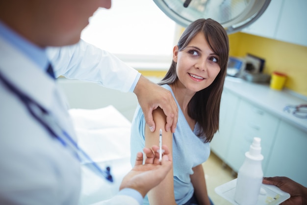 Doctor giving an injection to the patient