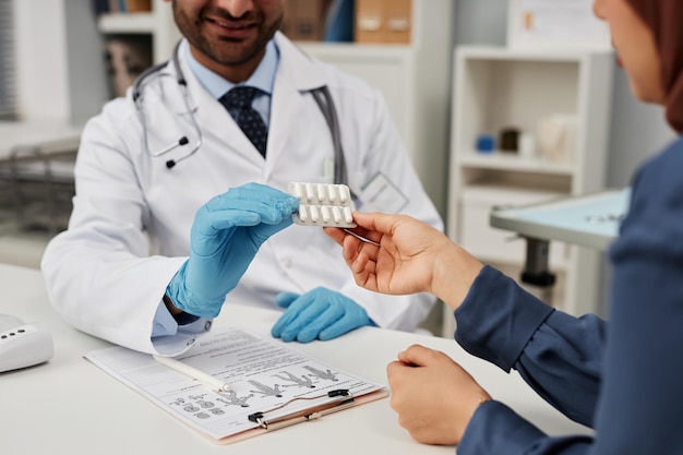 Doctor giving pills to woman