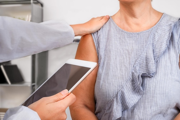 Doctor giving test results to senior patient in office