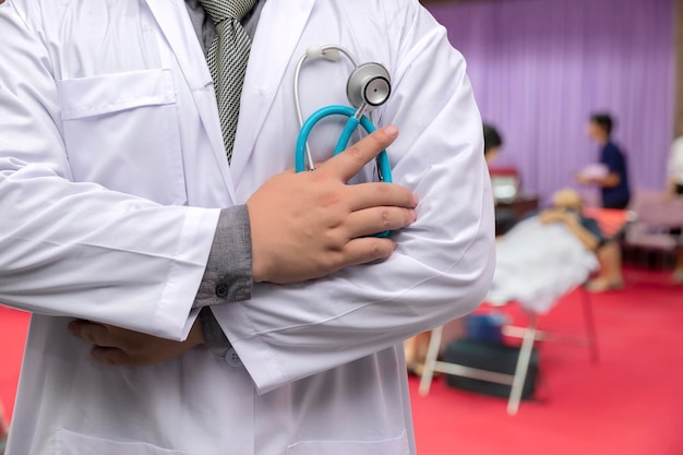 Doctor in gown uniform with stethoscope standing in blood donor room