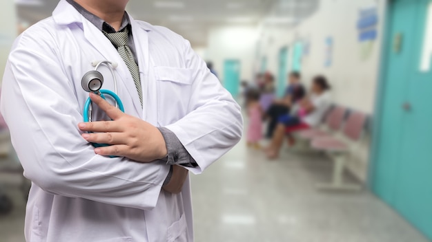 Doctor in gown uniform with stethoscope standing over the chest on OPD background