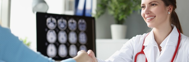 Doctor greeting patient at hospital with handshake