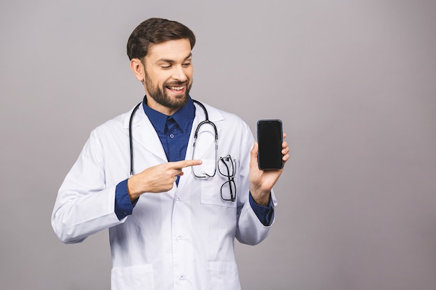 Doctor hand showing a blank smart phone screen application isolated on a grey background