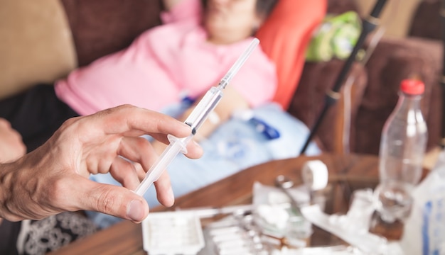 Doctor hand syringe. Making injection in patient