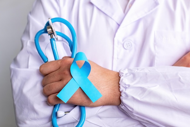 Doctor hands holding Light blue ribbon Prostate Cancer Awareness November blue Movember men health