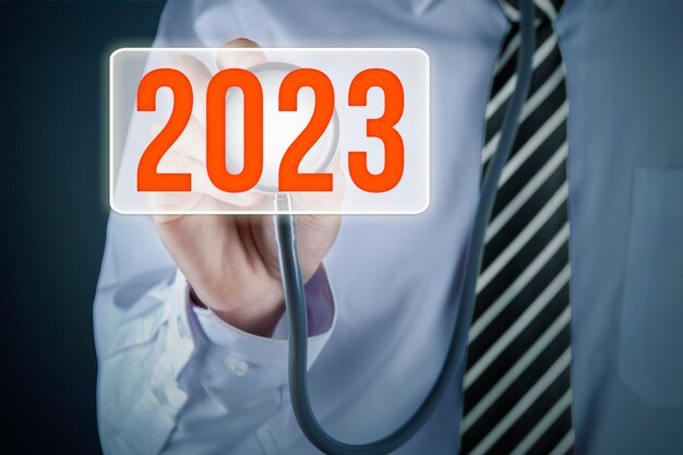 Doctor hands touch 2023 number on virtual screen