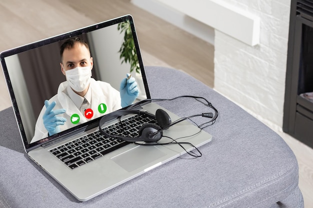 Doctor Having Video Conference On Laptop With Colleagues.