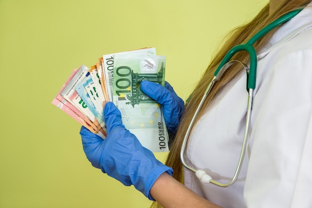 Doctor hold euro money  isolated on green