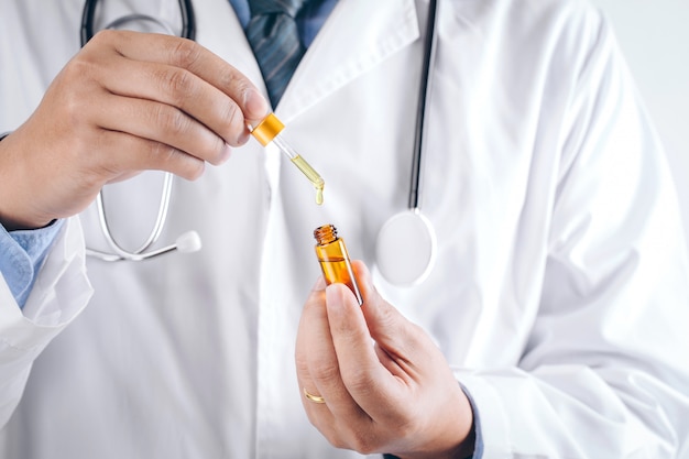 Doctor holding a bottle of hemp oil